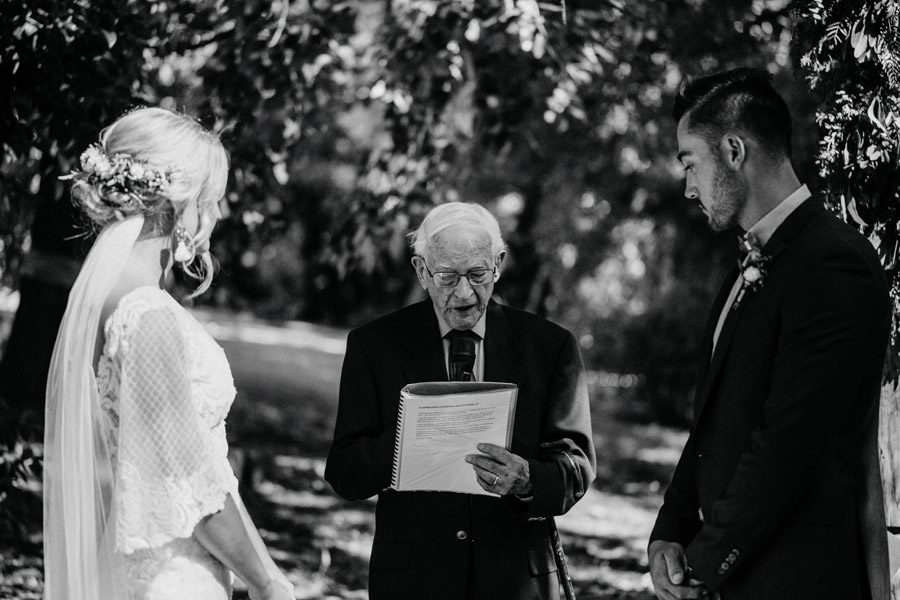 This outdoor wedding would have to be one of my all time favourite weddings. The wedding preparation took place at my old home in the Adelaide Hills, which was an Airbnb at the time. The lads kept it chilled, an easy morning at a family home in the Adelaide hills, a little hide away of their own. The wedding ceremony and reception took place at an old family holiday stay near Kangarilla. The bride would visit here frequently as a child. Her family grew up in these trees and gardens. So I can see why it was the most perfect place to have their wedding. An outdoor wedding photographers dream. Family was a big part of the day, which included the family dogs bringing the rings down the aisle to the couple. Locally sourced food trucks served the guests a selection of food like paella, pizza, burgers, local beers and espresso martinis later in the night. This is a great idea because it allows your guests to really choose what they would like to eat and I’m all for less waste. There was a stunning field right next to the main part of the wedding. We headed here for portraits. We were lucky enough to have a stunning sunset. Styling for the wedding was planned and designed by the couple and their friends. Beautifully sourced tables and chairs, plus other great lighting ideas and props. An intimate occasion with around 120 guests, made for a great atmosphere on the property gardens. A great idea was to have music videos playing on a big screen, which added really unique touch to the dance floor. I noticed people dancing and then laughing or dancing more because of the clips. Memory lane would definitely taken people back down memory lane. Please enjoy the photographs below, as much as I did photographing this wedding.